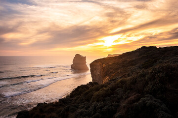 Gibson Steps at Sunset, Melbourne, Victoria, Australia. Colorful sky and clouds on a pristine beach with cliffs, vegetation and ocean composing the landscape.