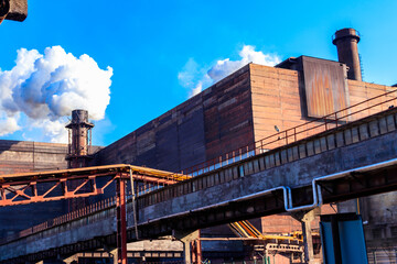 View of old factory with pipe with smoke. Air pollution, environmental damage