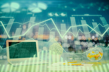 Forex graph hologram on table with computer background. Double exposure. Concept of financial markets.