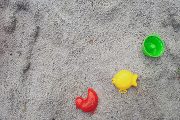 Sand toy on beach. Closeup pastic colorful toy for child. SToy items on the sand. childhood concept.