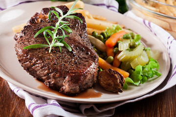 Beef steak served with baked potatoes