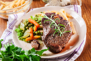 Beef steak served with baked potatoes