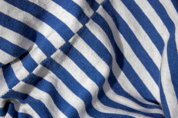 Shirt having a color in the form of alternating horizontal white stripes and stripes of a different...