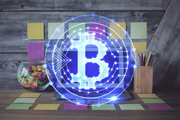 Double exposure of blockchain and crypto economy theme hologram and table with computer background. Concept of bitcoin cryptocurrency.