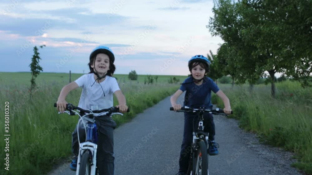 Sticker Children, boys, riding bikes  together summer time on a rainy day