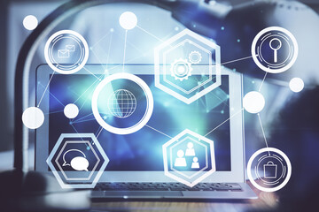 Computer on desktop with social network hologram. Double exposure. Concept of international people connections.