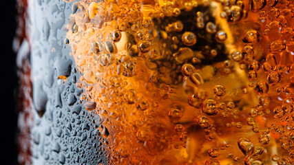 ice cube in fizzy splashing water with soda bubble