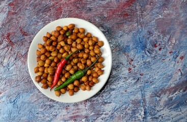 Wet Chickpea or Garbanzo Bean with Green Chilies in a Plate Isolated on Textured Background in Horizontal Orientation with Copy Space