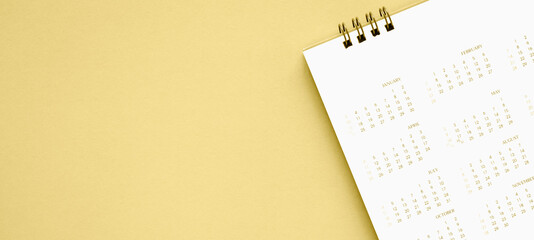 calendar page close up on gold background business planning appointment meeting concept