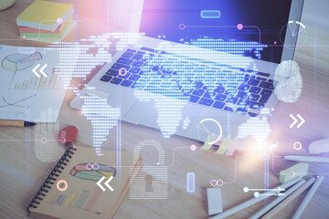 Obraz premium Multi exposure of table with computer and world map hologram. International data network concept.