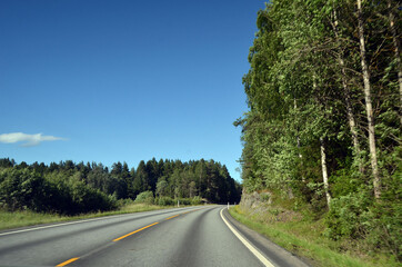 Fototapeta premium A typical Norwegian road in the countryside. Ostfold Region, Norway
