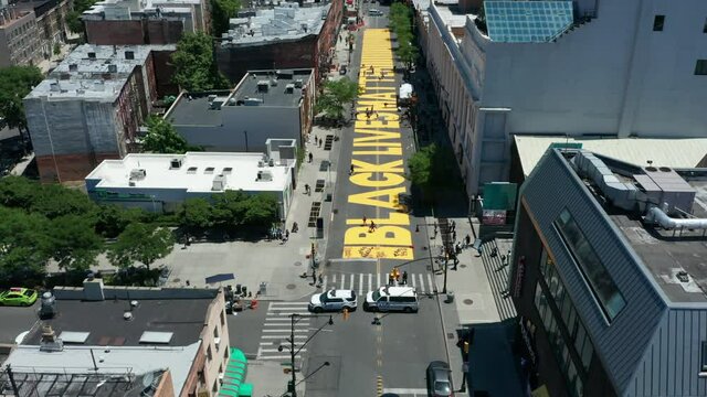 lower flying over BLM sign on Fulton St. in Bed Stuy Brooklyn