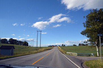 Fototapeta premium A typical Norwegian road in the countryside. Ostfold Region, Norway