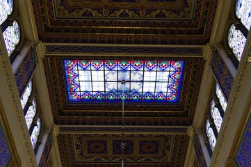 Obraz premium Prague, Czech Republic - 30 December 2019: interior of the Jeruzalémská synagoga wich has a Moorish style with many chadeliers, oriental arches, golden decorations and biblical verses on the wall
