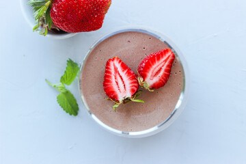 Chocolate dessert decorated with strawberries and Melissa leaves