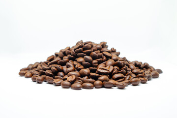 Brown dark roasted coffee beans isolated on white background. Group agriculture seed nature grain arabica.