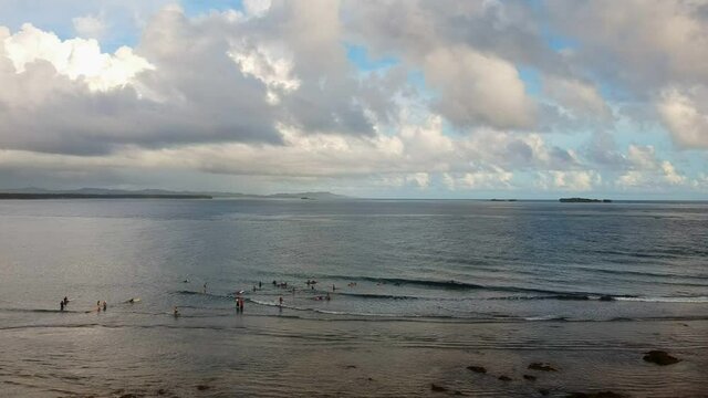 People learning how to surf in Siargao shot with a drone
