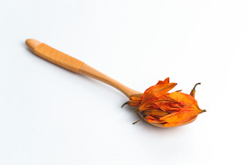 Lily tea on a wooden spoon