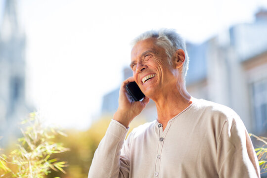 Close Up Happy Older Man Talking With Mobile Phone Outside