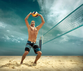 Beach volleyball player in action at sunny day under blue sky.