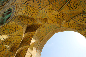 Naklejka premium The beautiful golden or yellow carving dome of Jameh Mosque of Isfahan: Jame Mosque or Imam Mosque or Shah mosque, The popular public landmark located in Imam square, Esfahan city, Iran