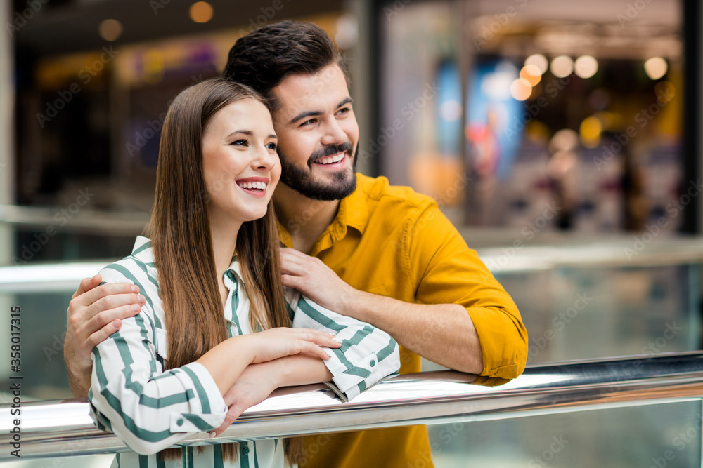 Poster Close-up portrait of his he her she nice attractive lovely charming tender cheerful cheery couple embracing spending free time watching concert visiting commercial building indoors