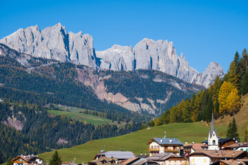 Fototapeta na wymiar Autumn alpine Dolomites scene, Moena, Sudtirol, Italy. Peaceful rocky mountain tops view.