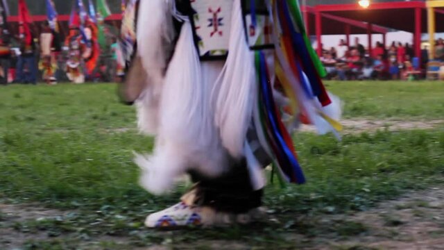 Lakota Dancers marching as they dance in their traditional clothes demonstrating their history and culture.