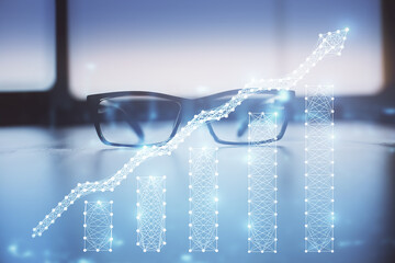 Financial graph hologram with glasses on the table background. Concept of business. Double exposure.