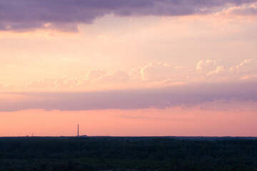 Amazing red sunset, clouds and the dark silhouette of the city