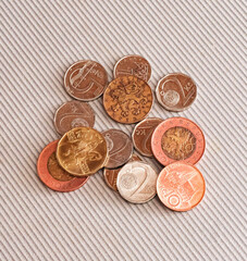 Many different coins from different countries from the black wallet are scattered around the table: dollars, pounds, rubles, pennies, cents, yuan. Saving money, losing finance, earning.