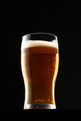 Glass of beer on black background, copy space