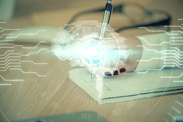 Multi exposure of woman's writing hand on background with brain hologram. Concept of brainstorming.