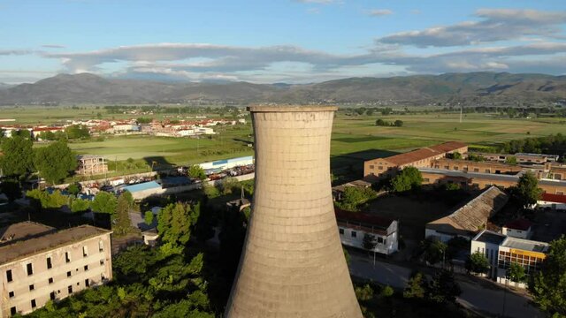 Tower of coal plant station out of work, standing on rural area of old city of Korca in Albania