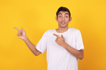 young teenager man pointing isolated on color background with white t-shirt