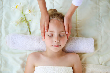 Masseur doing face massage to child.