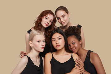 The real beauty exists in every corner of the world and is presented by women of all races. Group portrait of five beautiful ladies in black tops and with different skin and hair colour.