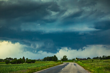 Fototapeta na wymiar Supercell storm clouds with wall cloud and intense rain