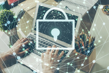 Multi exposure of lock icon with man working on computer on background. Concept of network protection.