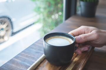 Cropped shot of man holding cup of coffee. Hot latte the best start to any morning.