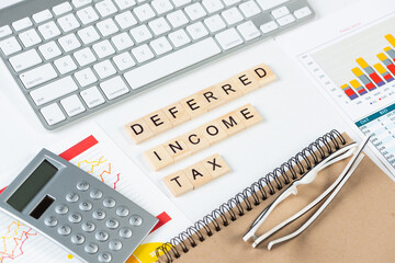 Deferred income tax concept with letters on cubes