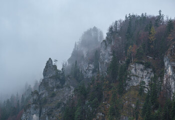 Mystic cloudy and foggy autumn alpine mountain slopes, Austria