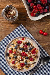 Breakfast, muesli with milk and fresh fruit.