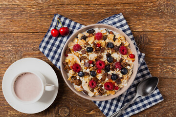 Breakfast, muesli with milk and fresh fruit.