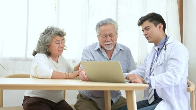 Asian elder couple are meeting doctor at home.
