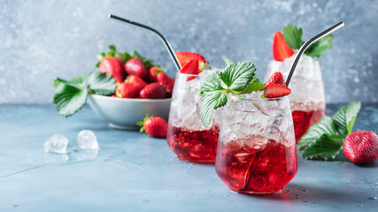 Red cocktail with ice and fresh strawberry