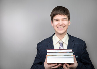 A boy with books goes to school
