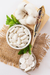 Nutrition supplements and meds in rustic style on a white background. Vitamins for good health.