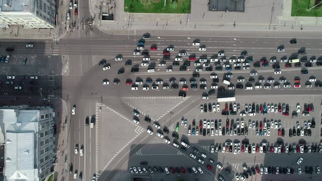 Aerial top view car free parking space. Aerial view from above flying drone cars moving and standing on parking lot in modern city. Car traffic and parking concept. City filled with cars, city ecology
