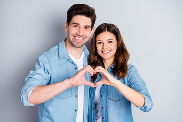 Photo pretty lady handsome guy couple in love making fingers hands heart figure celebrate...